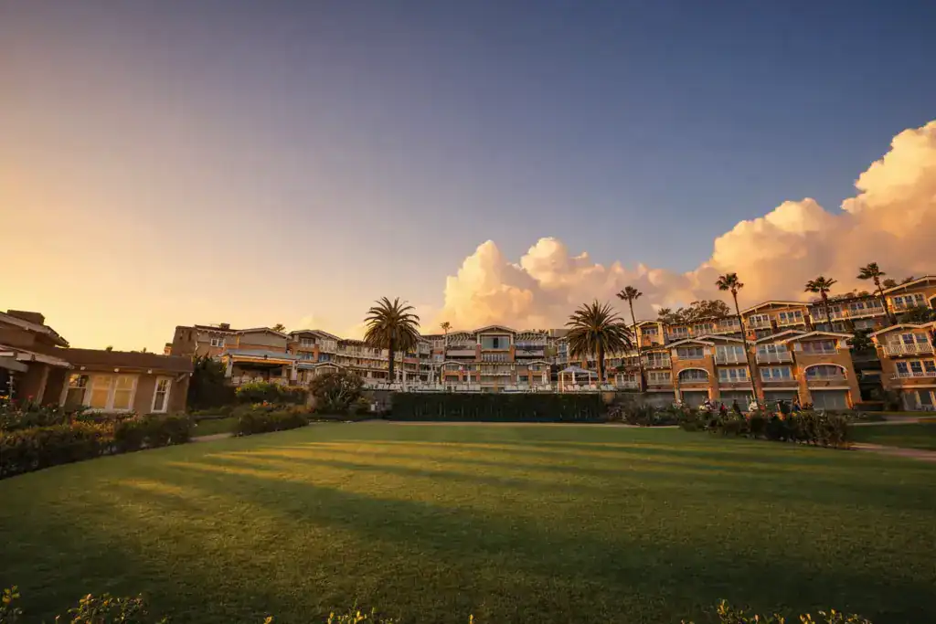 A wide-angle view of a vast, high-end artificial turf lawn at a coastal resort