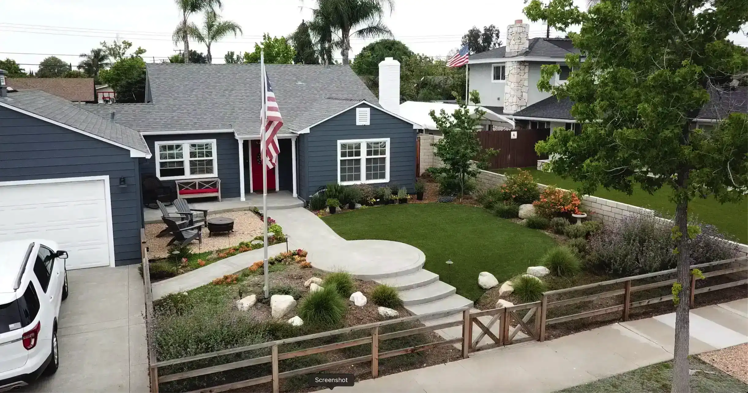 Custom outdoor living space with covered patio, fire pit, and seating area