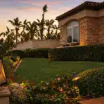Front yard with artificial grass lawn, clean edging, and enhanced curb appeal