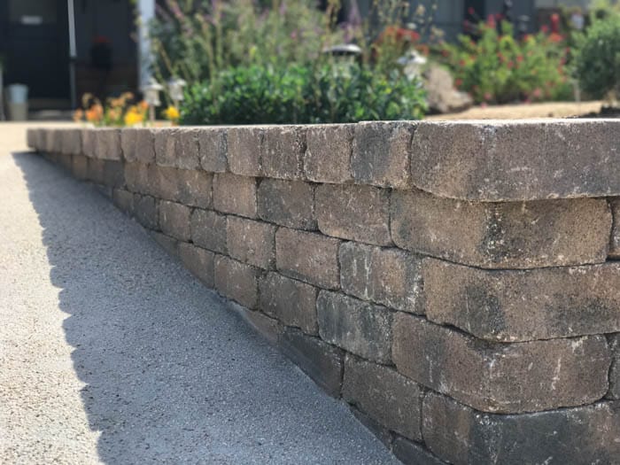 Ecoworkz retaining wall with paver landscaping and garden design