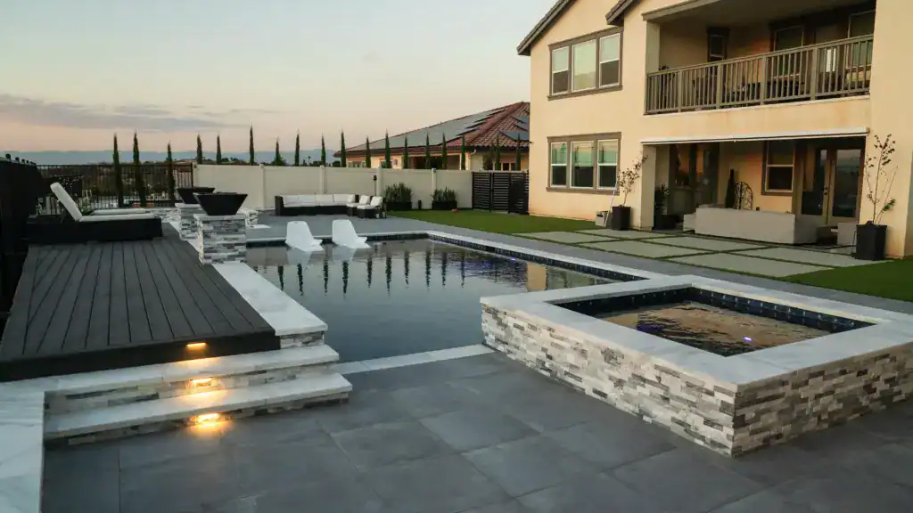 modern backyard with a sleek swimming pool and a hot tub
