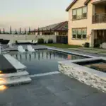 modern backyard with a sleek swimming pool and a hot tub