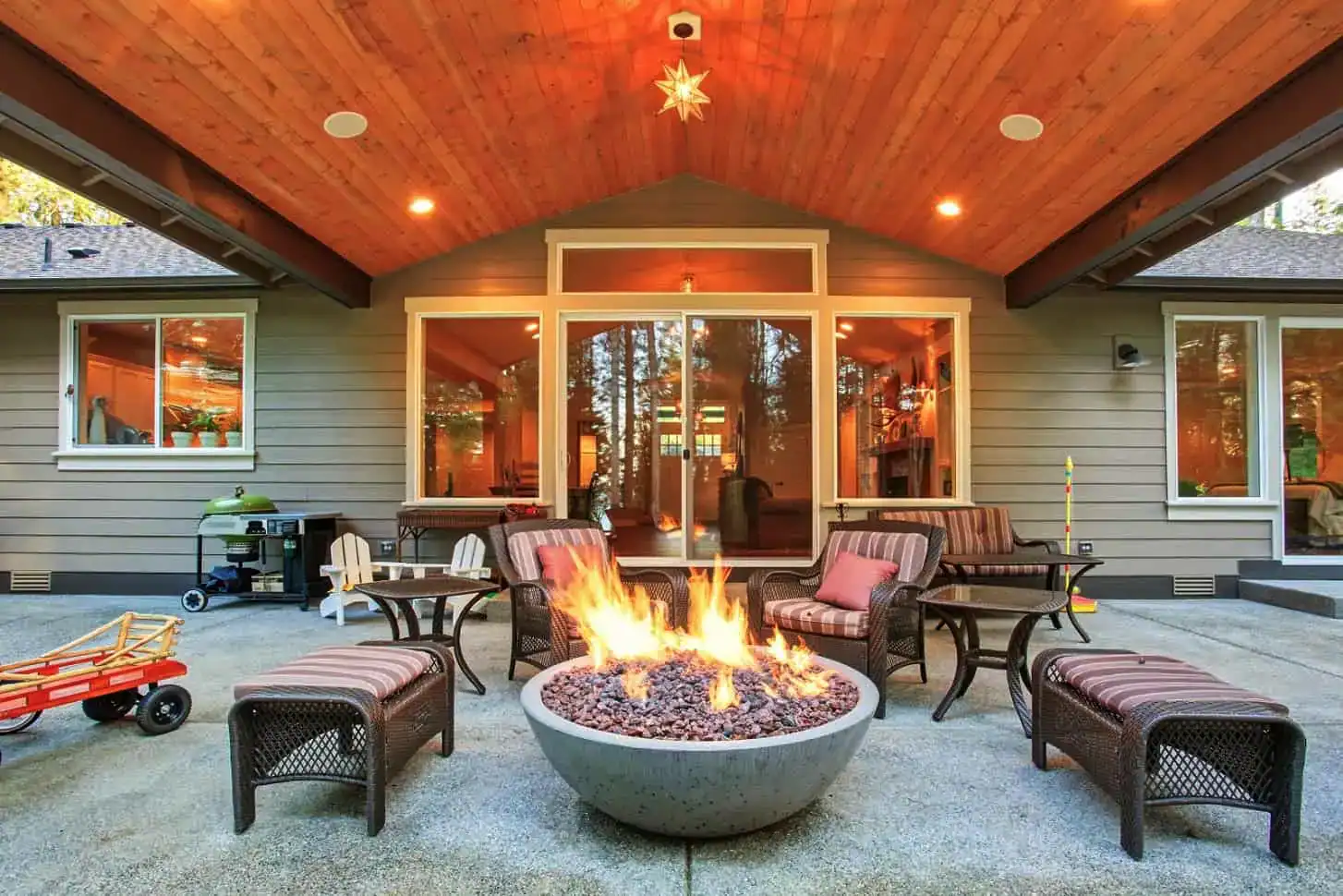 Custom covered patio with built-in fire pit and outdoor seating designed for backyard living