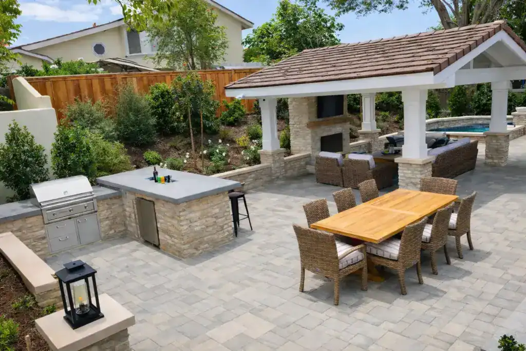 well-designed outdoor patio area featuring a dining table with wicker chairs